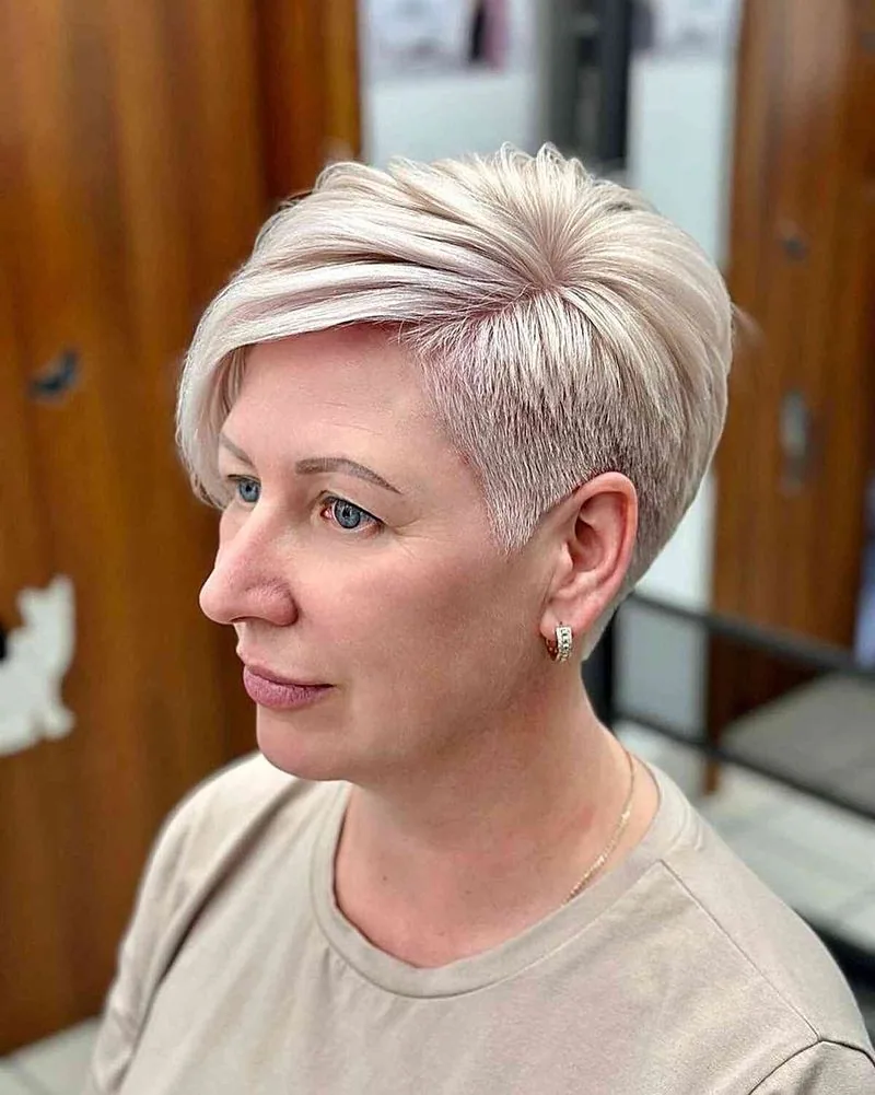 chin straight silver pixie with side swept fringe shown as a hairstyles for women over 40 with bangs idea