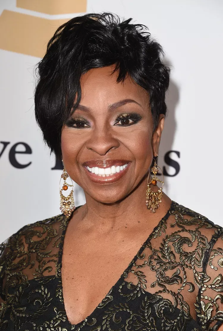 ear straight black pixie with side swept fringe shown as a hairstyles for women over 40 with bangs idea, featuring medium layering