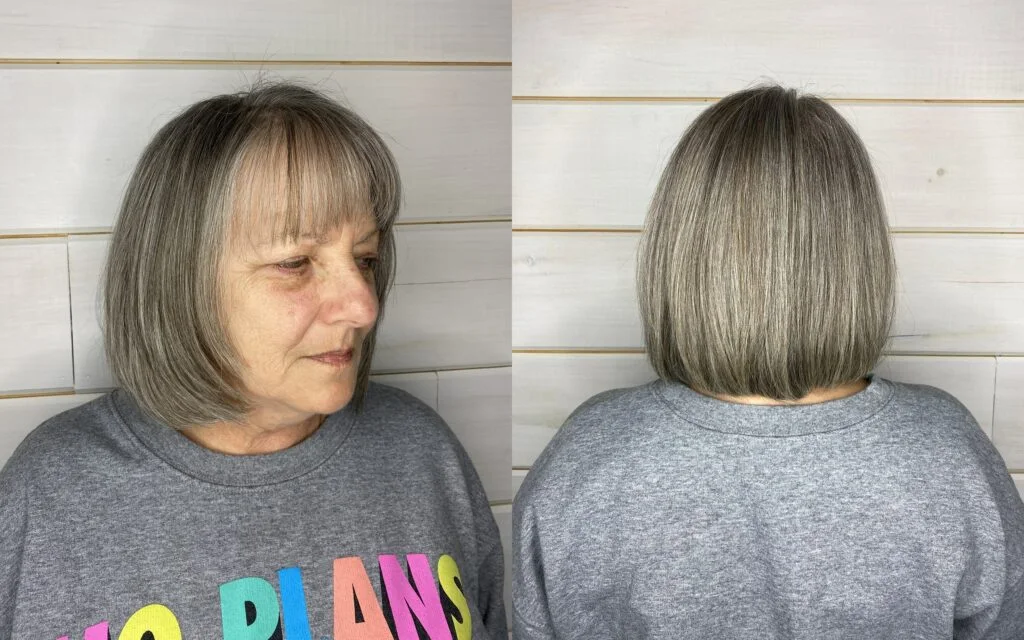 chin straight silver bob with blunt fringe shown as a hairstyles for women over 60 with thin hair idea