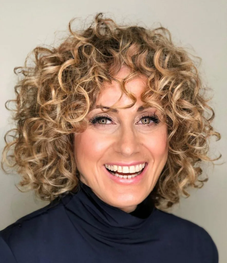 neck curly silver curly style shown as a hairstyles for women over 60 with thin hair idea, featuring natural finish