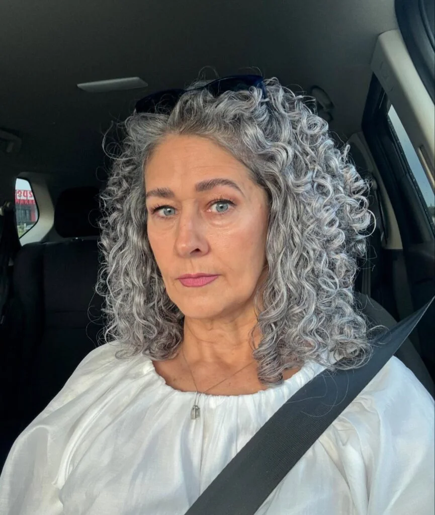 neck curly silver curly style shown as a hairstyles for women over 60 with thin hair idea, featuring volume through the all over