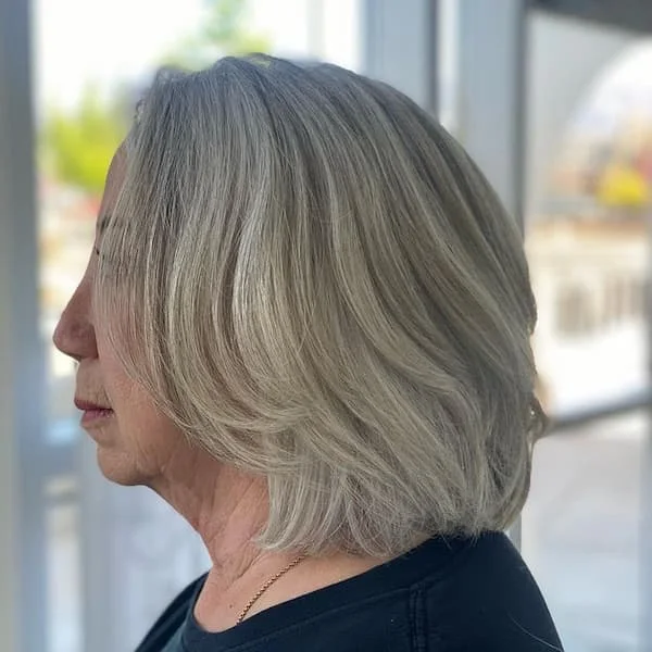 neck straight silver bob shown as a hairstyles for women over 60 idea, featuring silver color