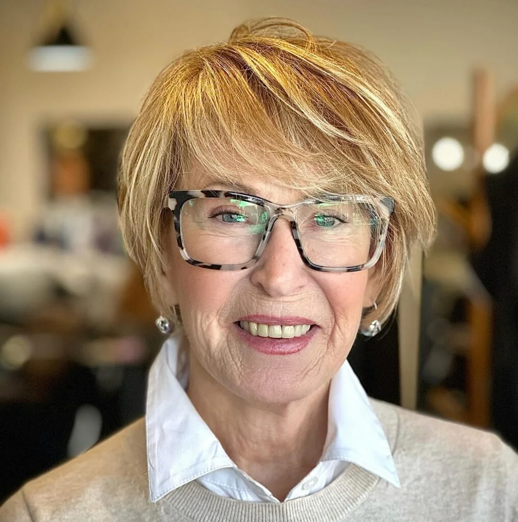 ear straight blonde pixie with side swept fringe shown as a hairstyles for women over 60 idea