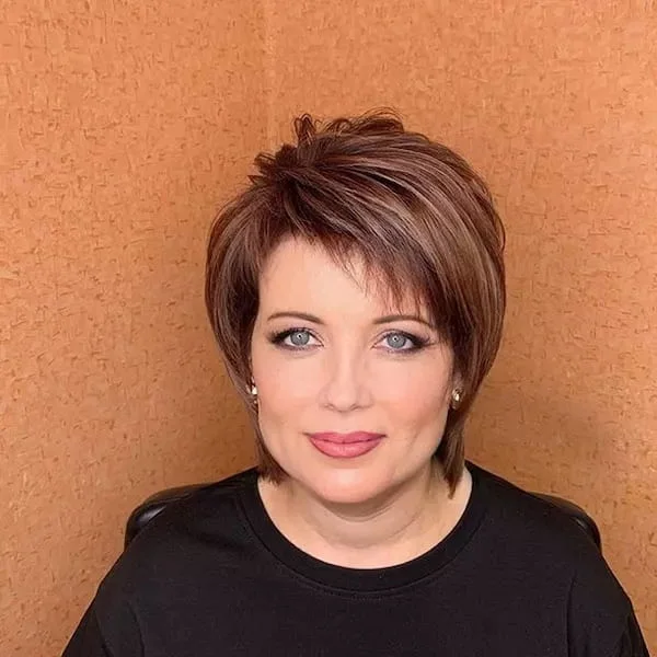 ear straight chestnut pixie with side swept fringe shown as a hairstyles for women over 60 idea
