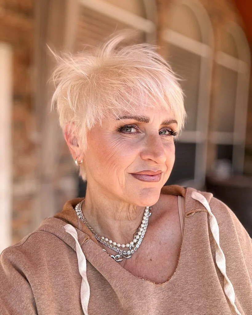 ear straight blonde pixie with micro fringe shown as a hairstyles with bangs for older women idea