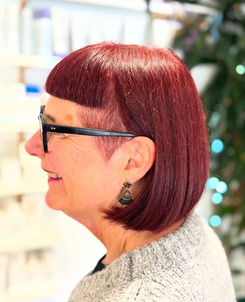 chin straight auburn bob with blunt fringe shown as a hairstyles with bangs for older women idea
