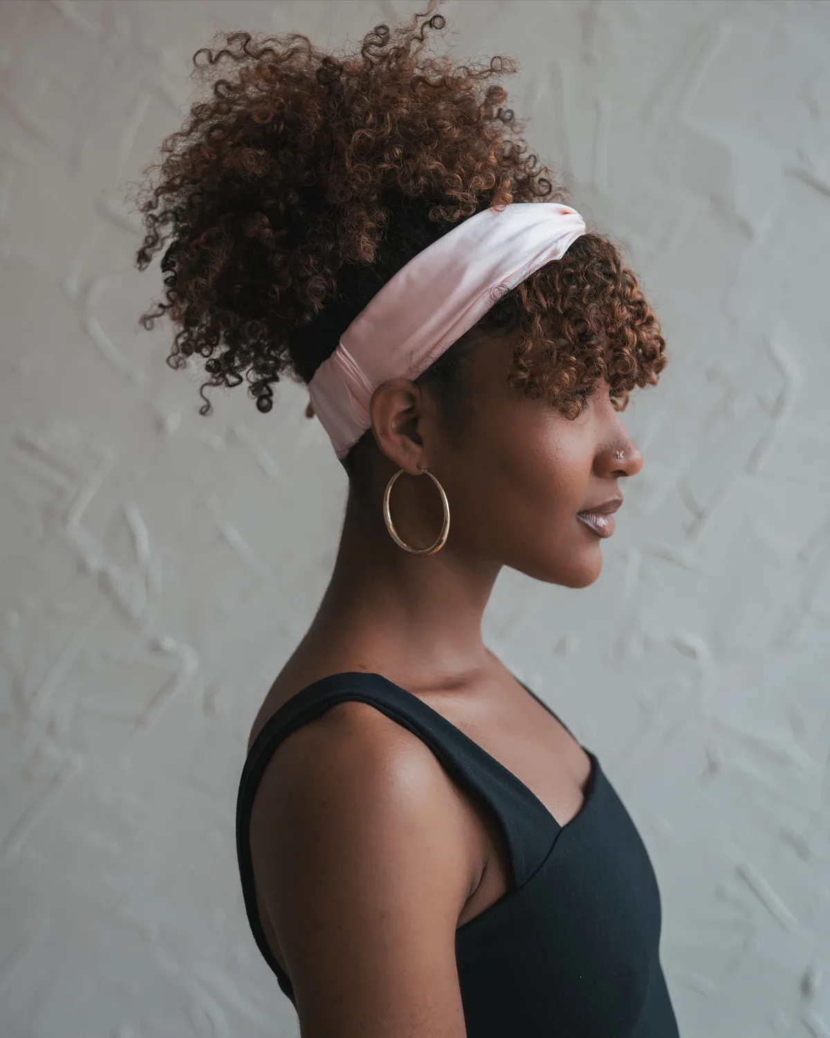 shoulder coily brunette ponytail shown as a headband hairstyles idea