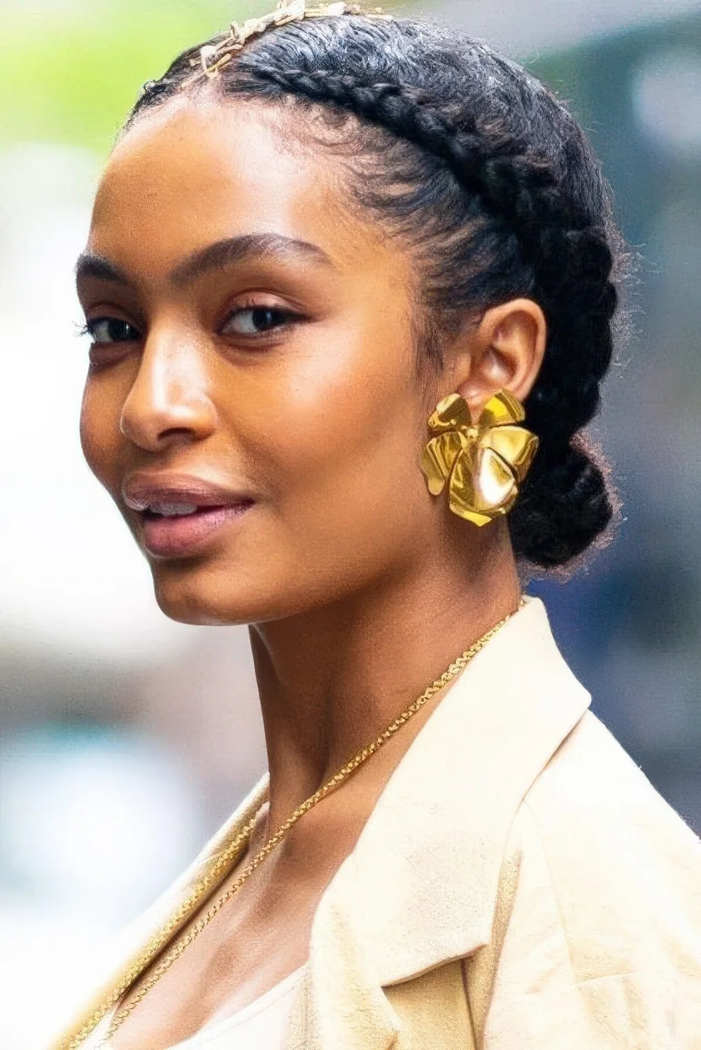 Braided low bun and braids on both sides of the head are a great and catchy holiday updo.