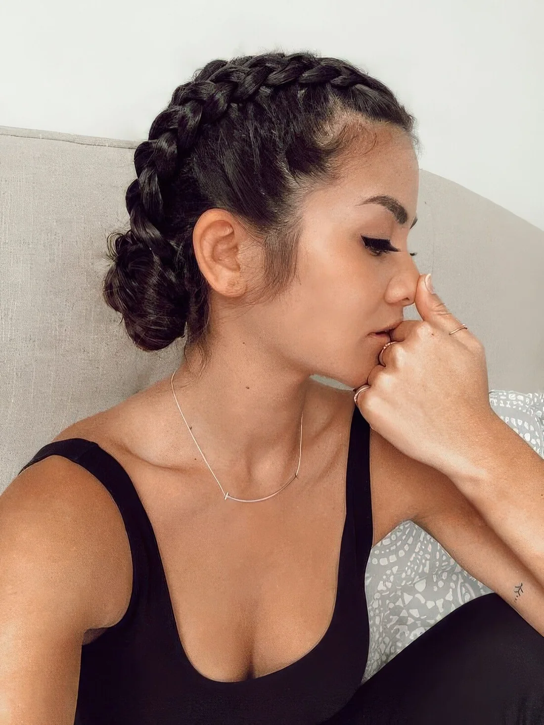Photo showing braided low updo with two buns, with the hairstyle clearly visible.