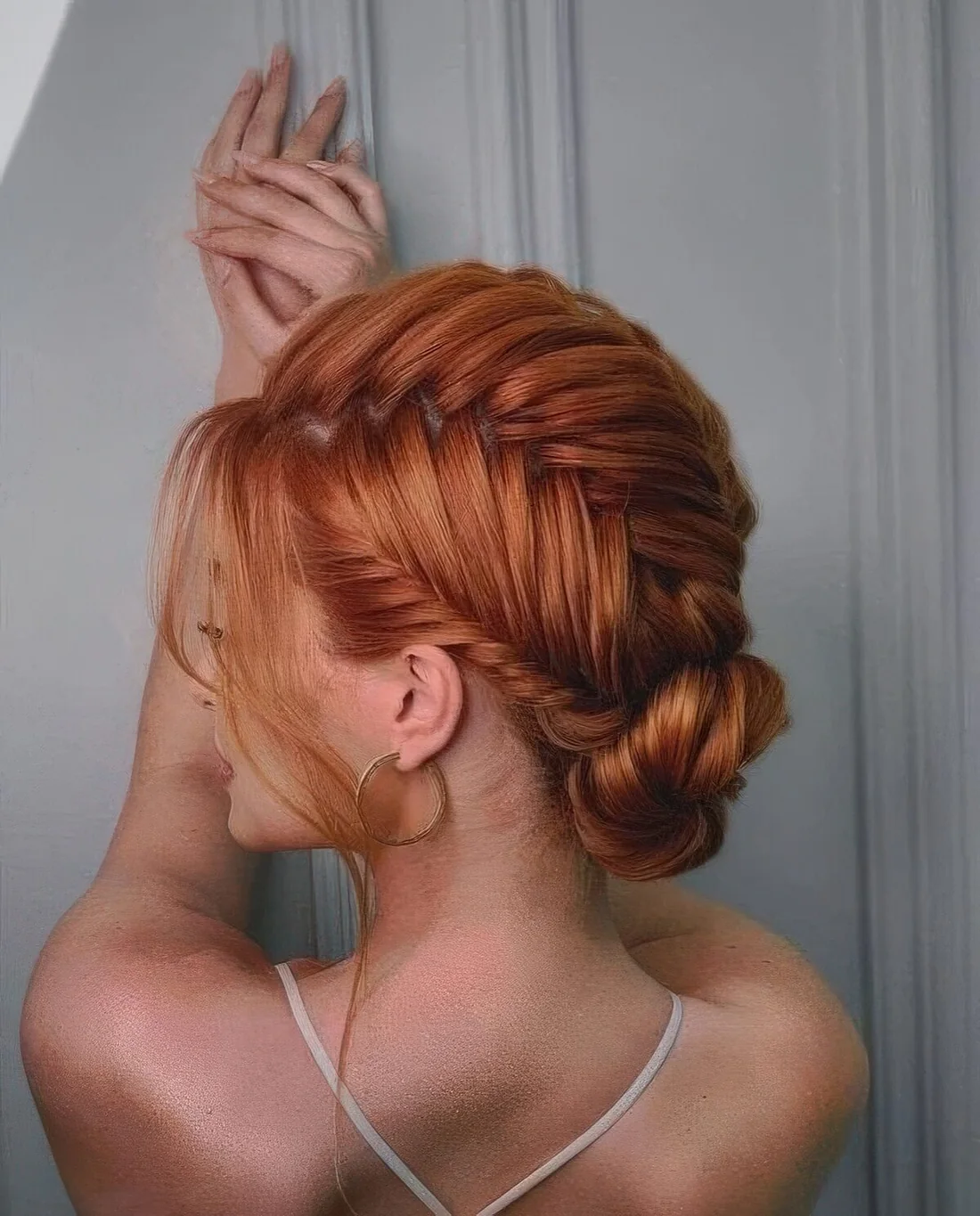 Braided updo with braids covering the whole head and a low bun plus some locks down.