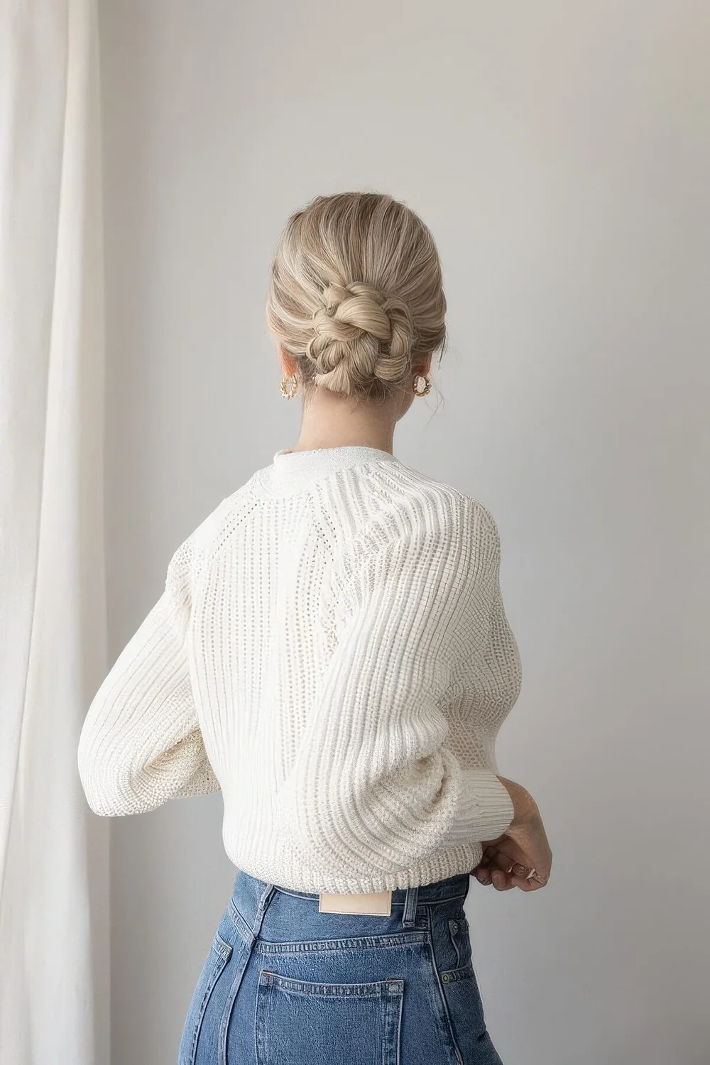 Braided low bun with a volume on top.