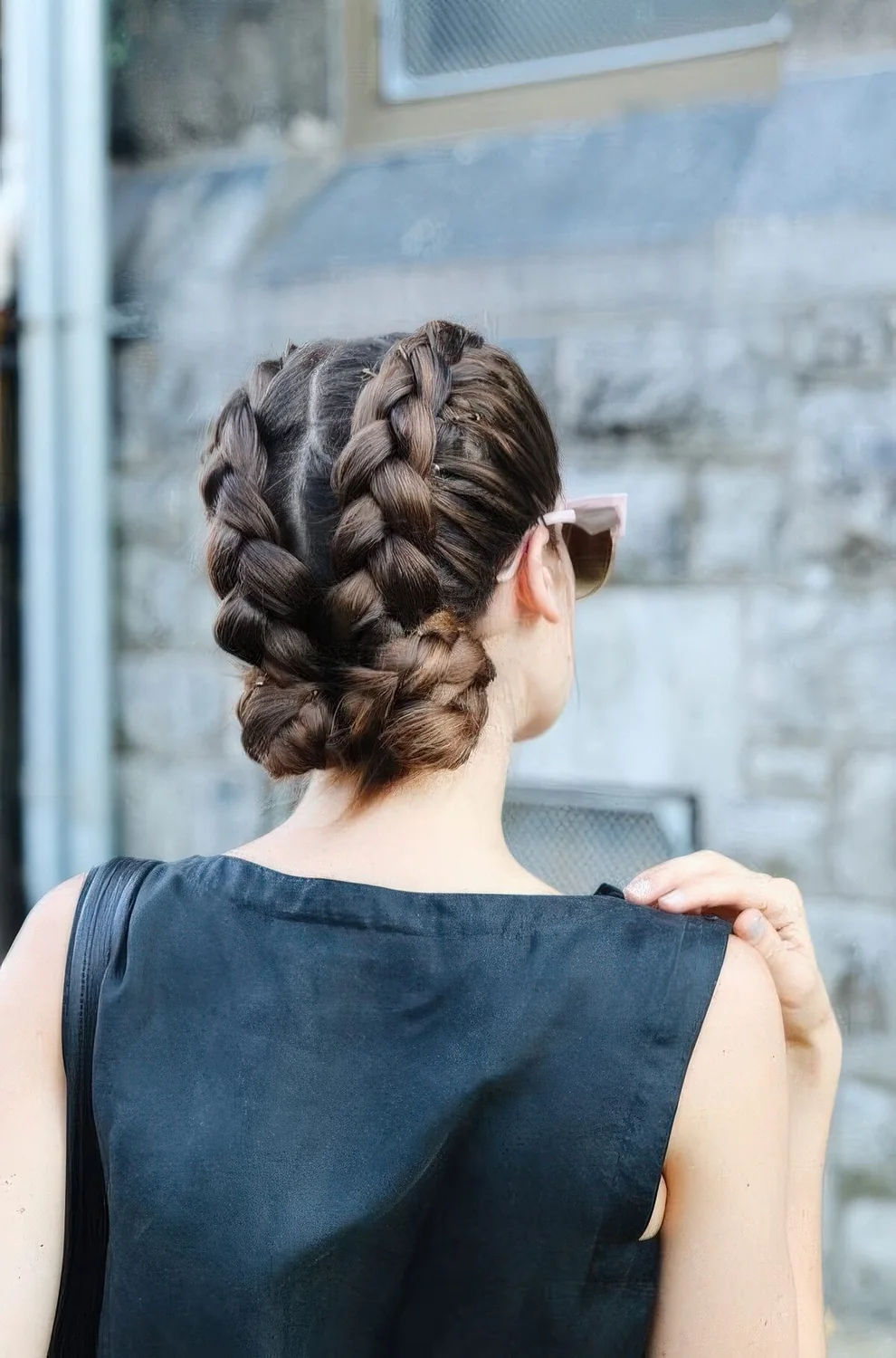 Two voluminous braids with large low buns are a catchy and bold solution for a bold holiday look.