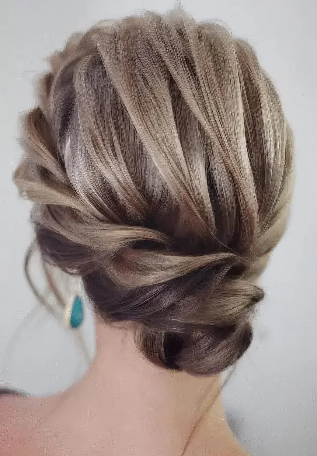 Exquisite low bun with a braided halo and a voluminous top plus locks down.