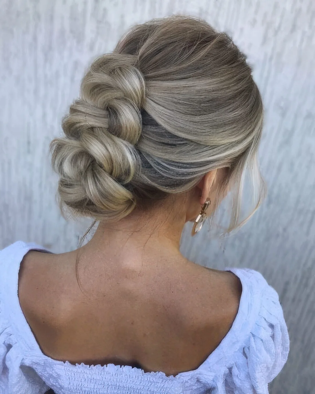 Photo showing braided updo with a bump on top, with the hairstyle clearly visible.