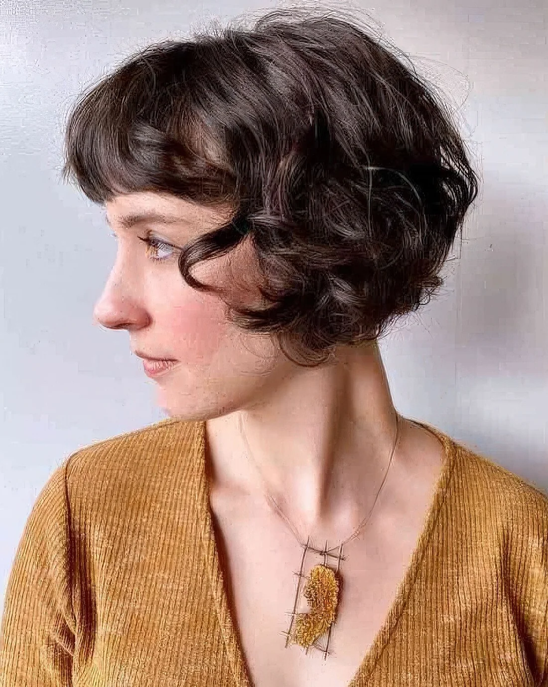 Curly French bob with soft, tousled curls.