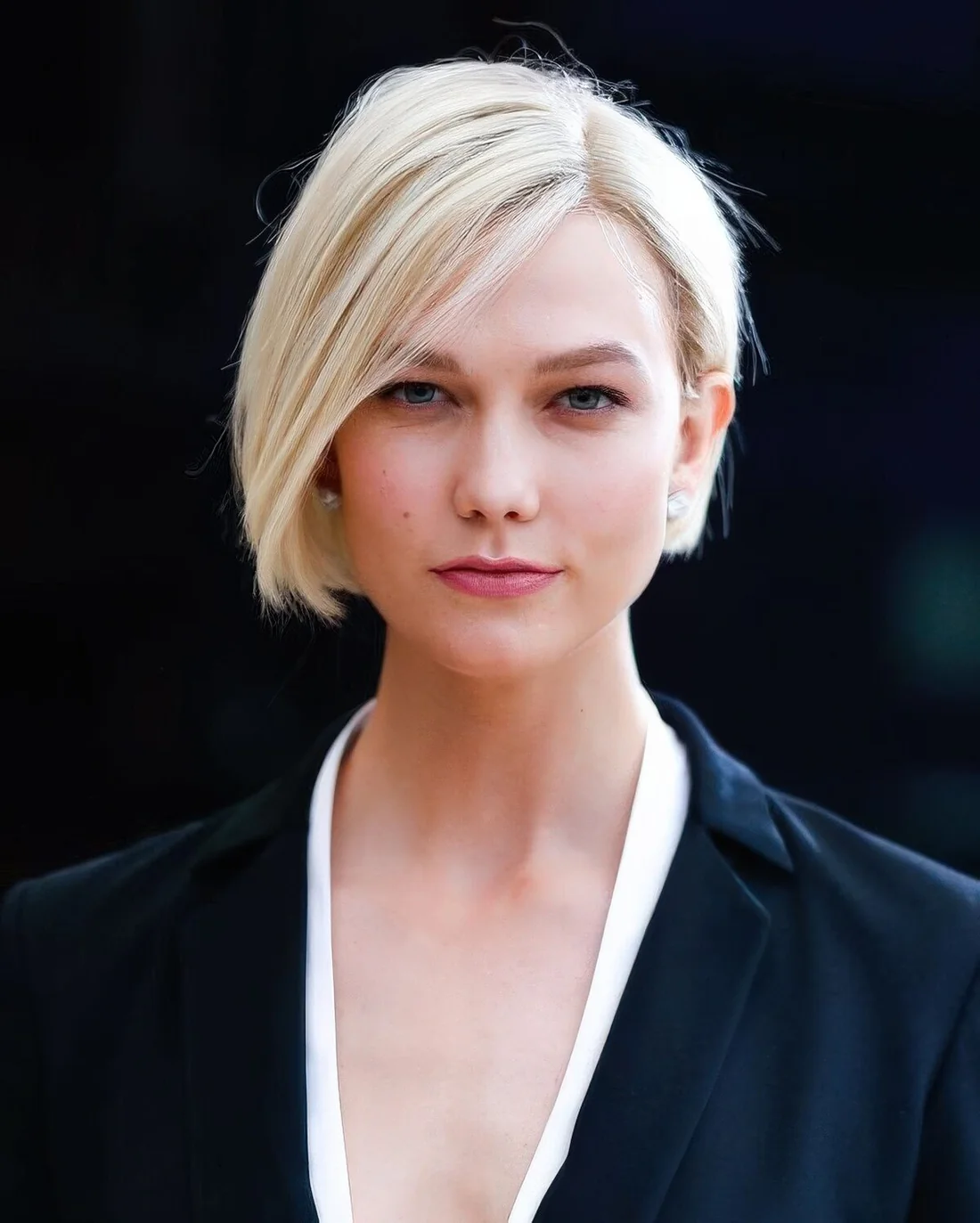 Creamy blonde sleek boy bob with side part and some volume already.