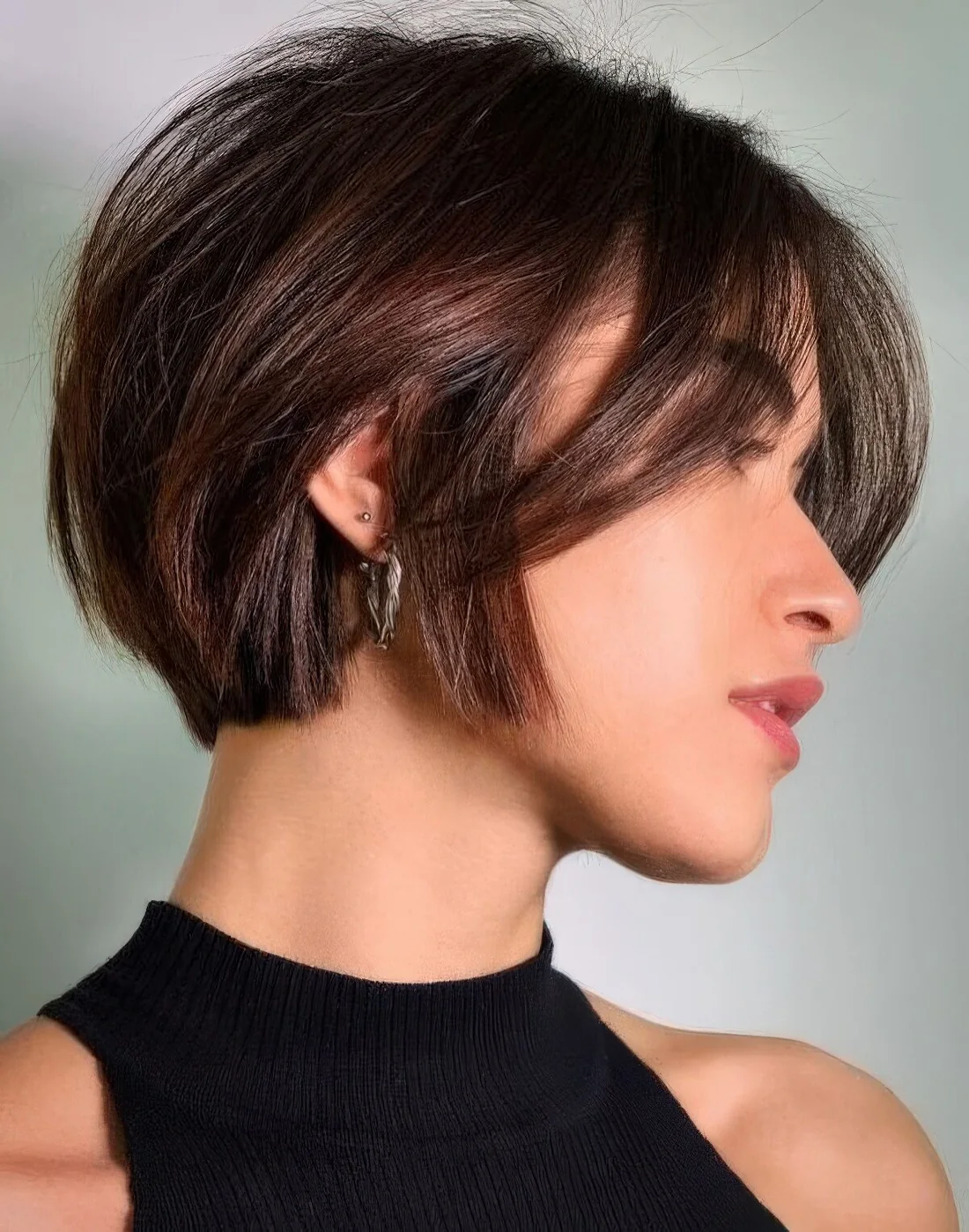 Short and textural bob with bangs in a beautiful chestnut shade.