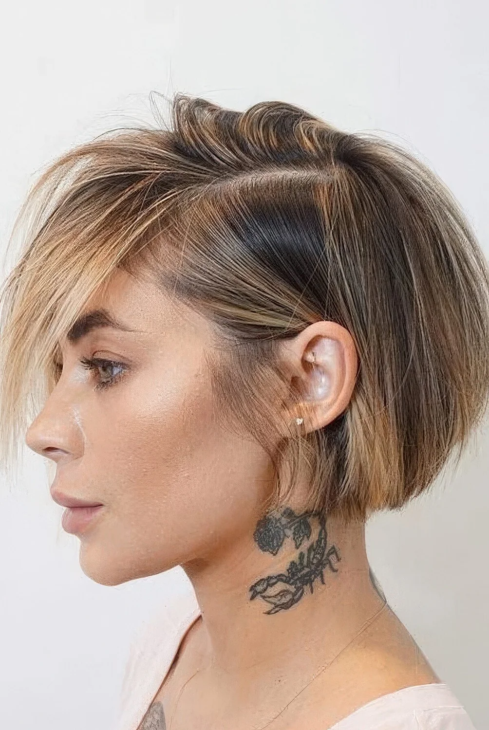 Straight short bob with blonde balayage including face-framing highlights.