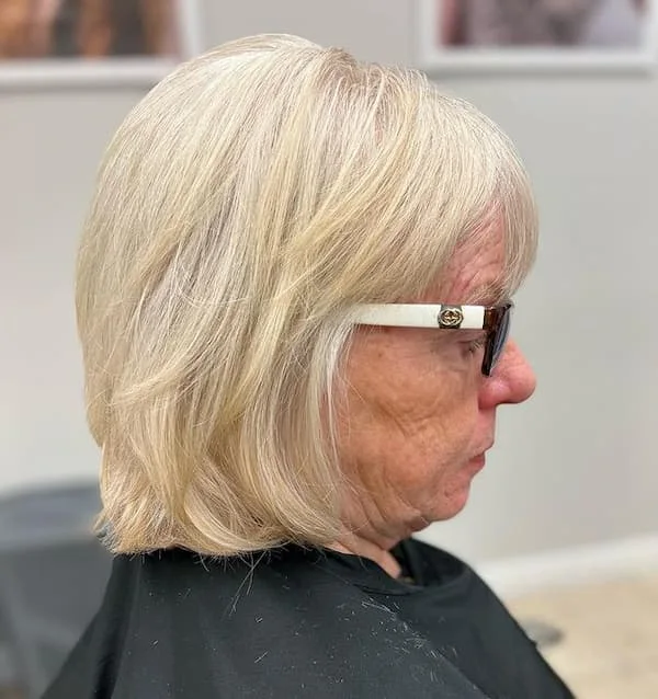 neck straight silver bob shown as a layered bob haircuts for women over 60 idea, featuring glossy finish