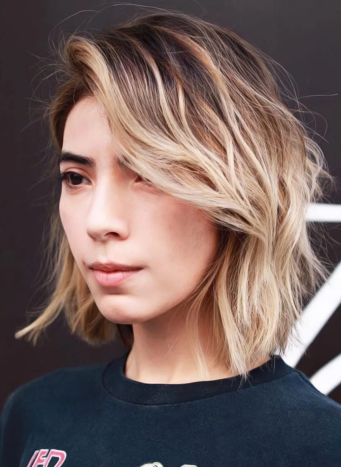 Blonde bob with long feathered layered and a lot of volume.