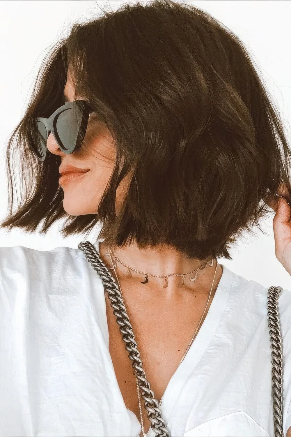 Photo showing dark wavy layered bob, with the hairstyle clearly visible.