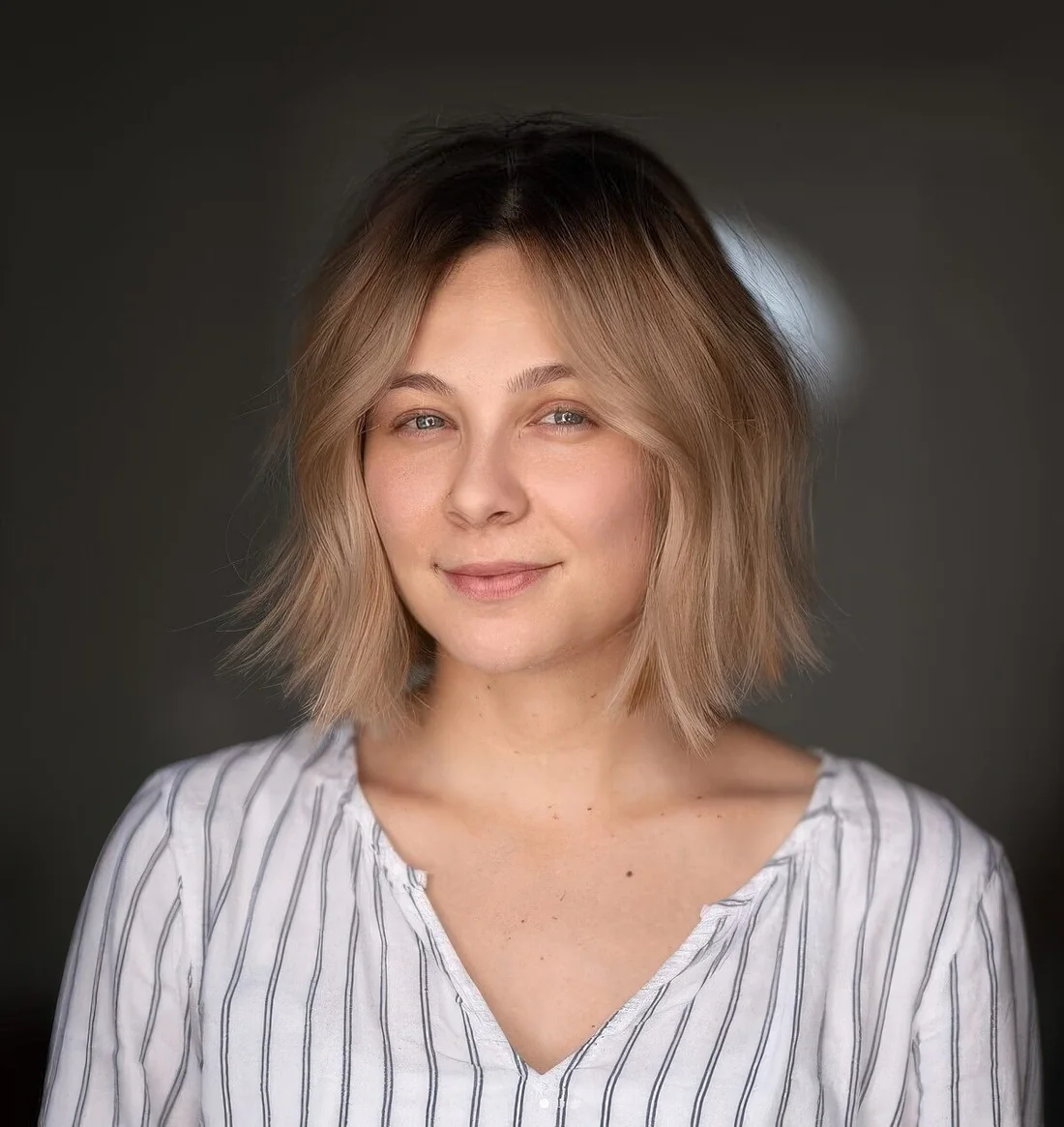 Layered bob with a darker root shadow and soft, brushed out waves for a very delicate and soft look.