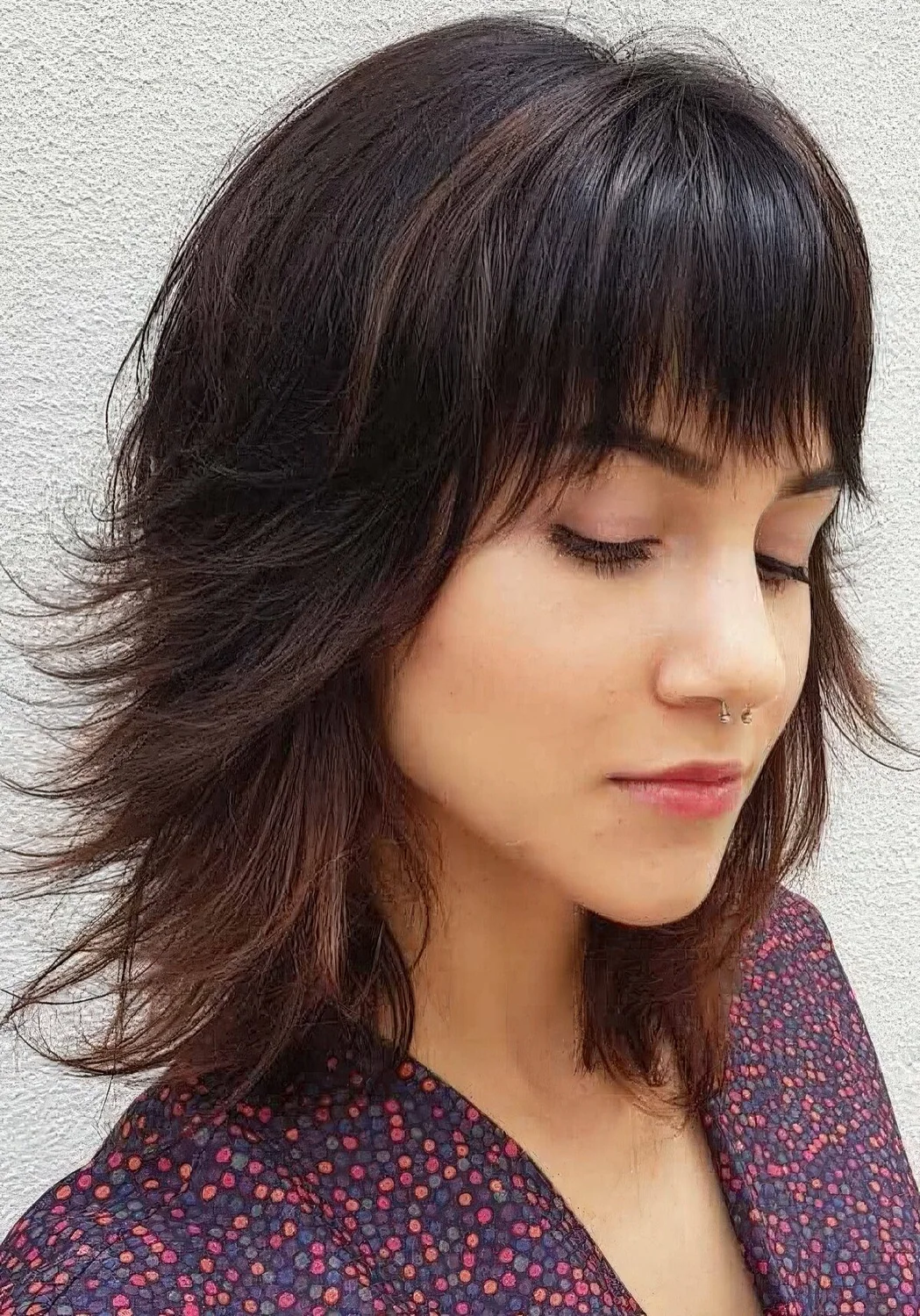 Long bob with bangs and flipped ends.