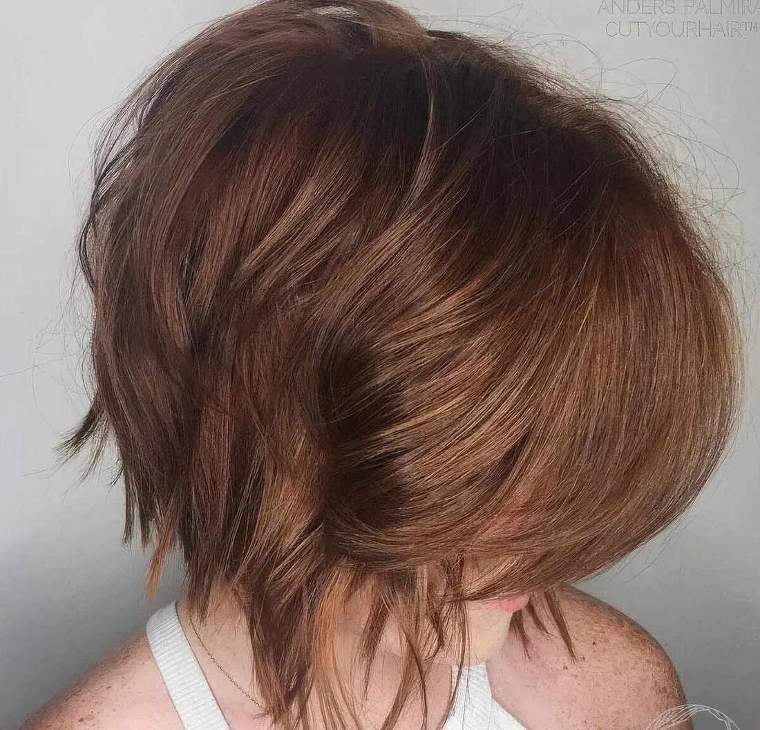 Peek a boo layered bob with a beautiful reddish tone and much volume.