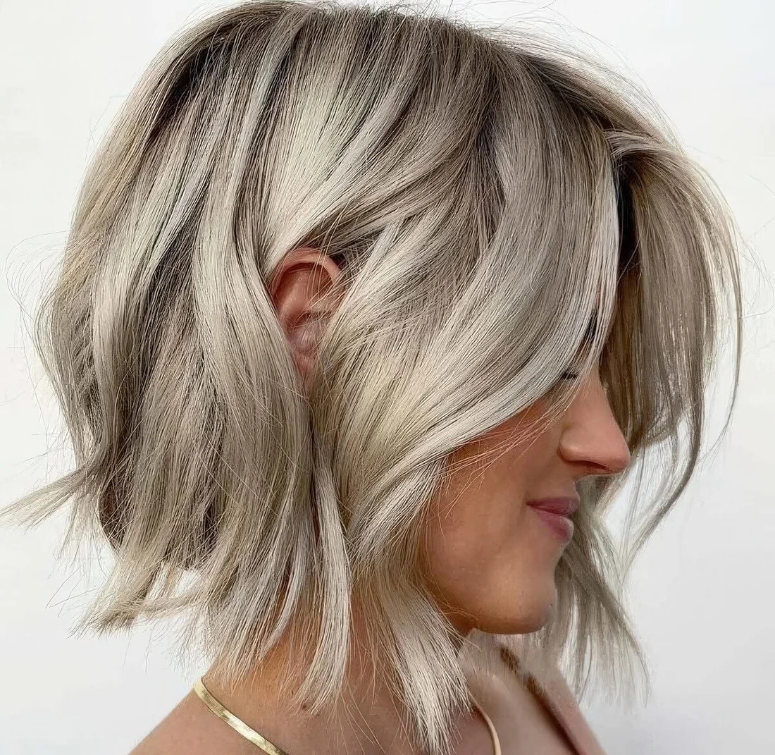 Photo showing silky cold blonde layered bob, with the hairstyle clearly visible.