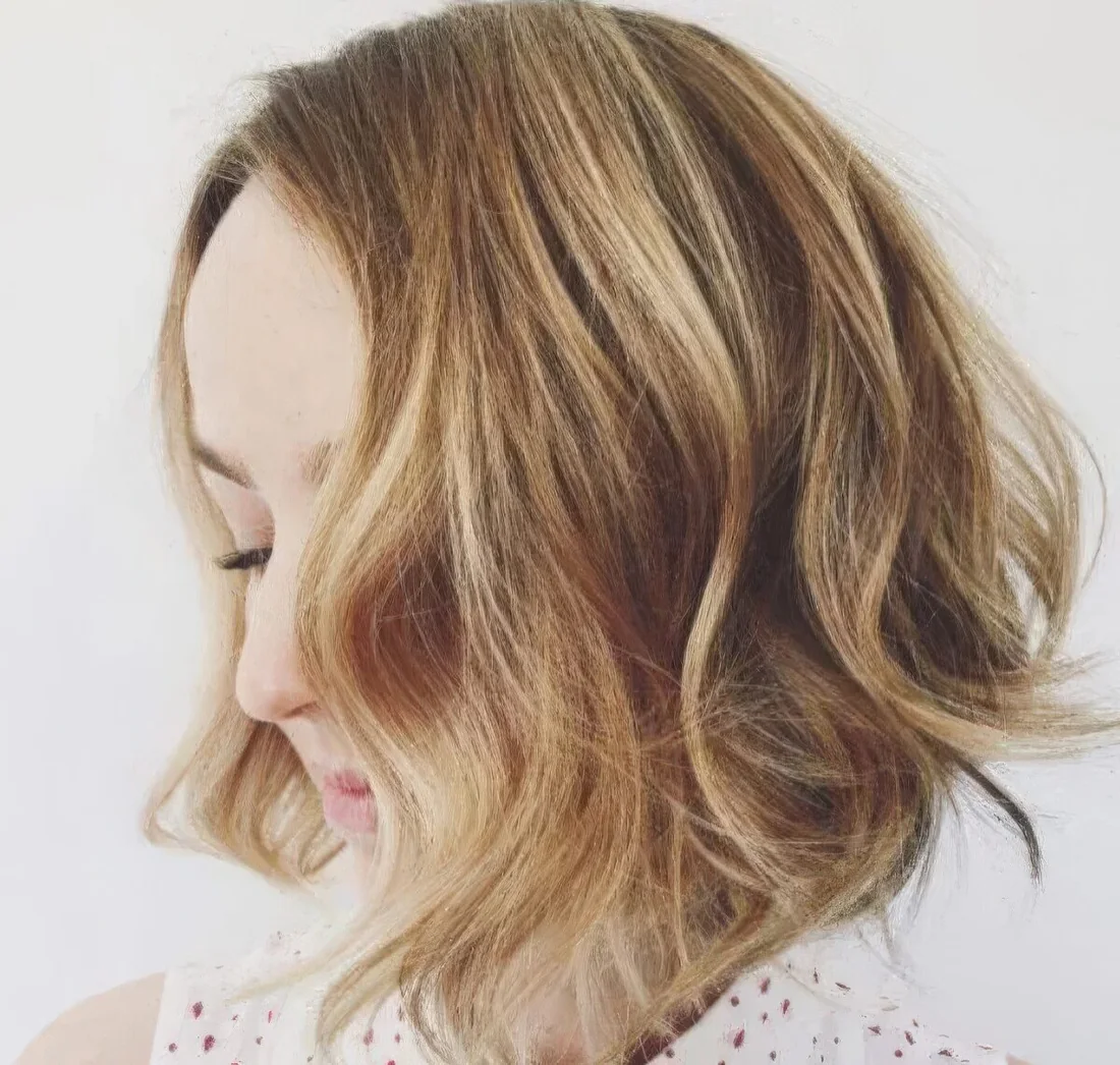 Textural layered light brown bob with classy Hollywood waves.