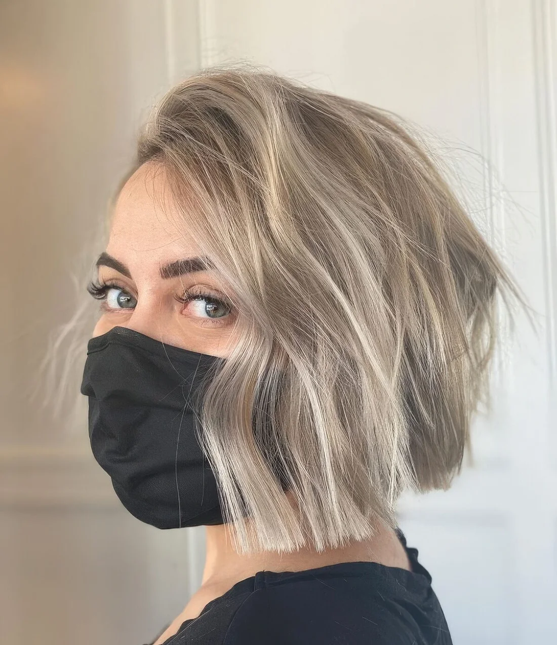 Photo showing ash blonde layered bob, with the hairstyle clearly visible.