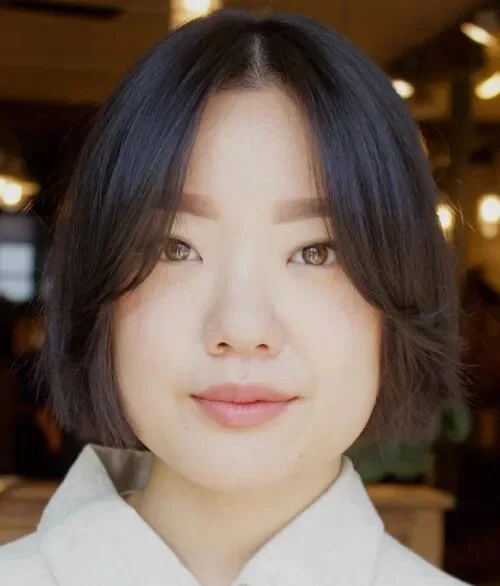 chin straight chestnut bob with curtain fringe shown as a layered bob with curtain bangs idea, featuring straight texture, shown in rounded black bob with long curtain bangs