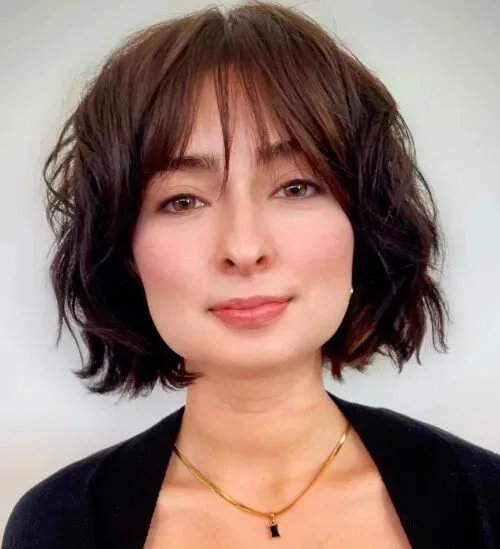 chin straight chestnut bob with curtain fringe shown as a layered bob with curtain bangs idea