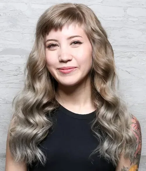 chest wavy gray layers with wispy fringe shown as a layered hair with bangs idea