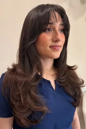 chest wavy chestnut layers with curtain fringe shown as a layered hair with bangs idea, featuring curtain fringe