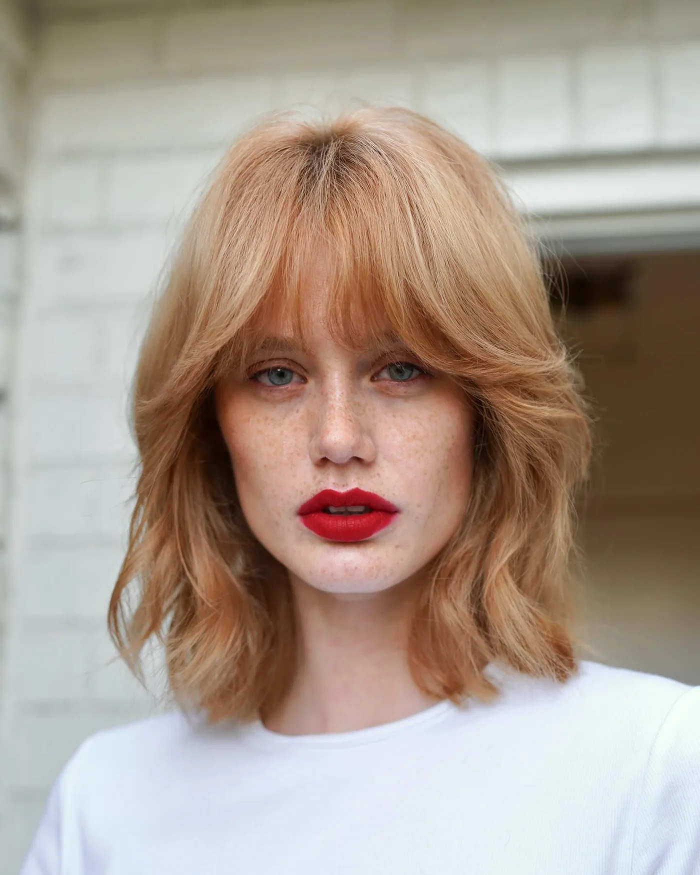 neck straight red bob with curtain fringe shown as a layered hair with bangs idea
