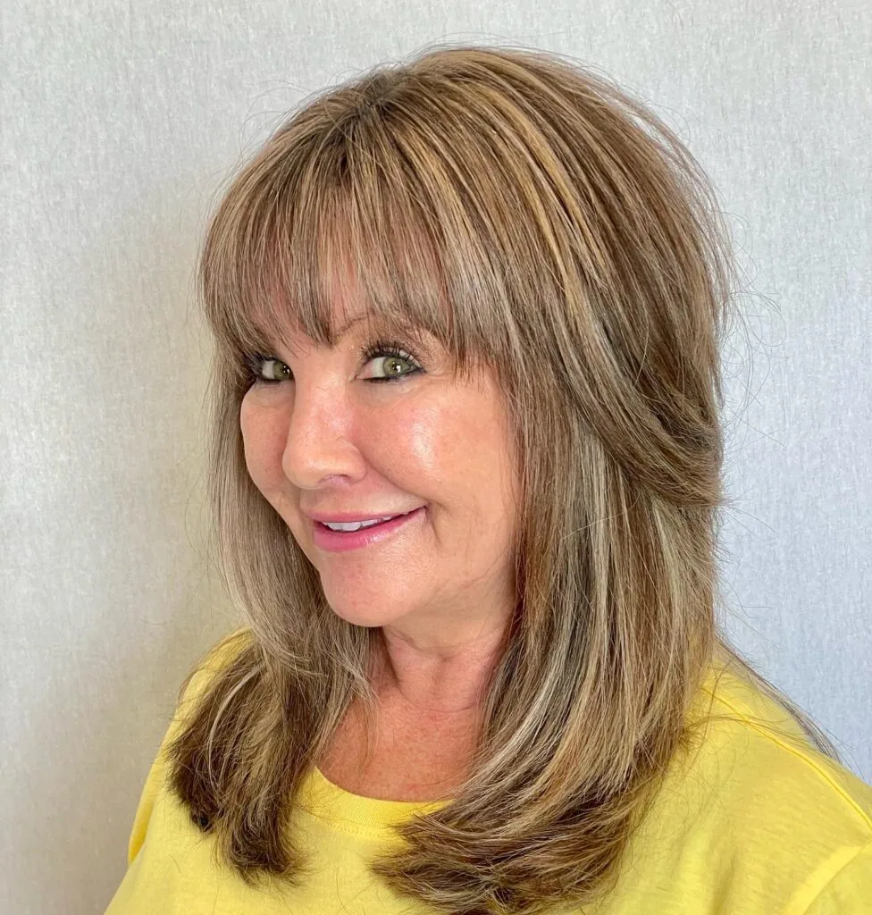 shoulder straight honey lob with curtain fringe shown as a layered hairstyles for women over 60 idea