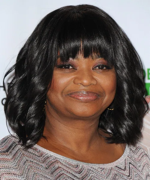 shoulder wavy black layers with curtain fringe shown as a layered hairstyles for women over 60 idea