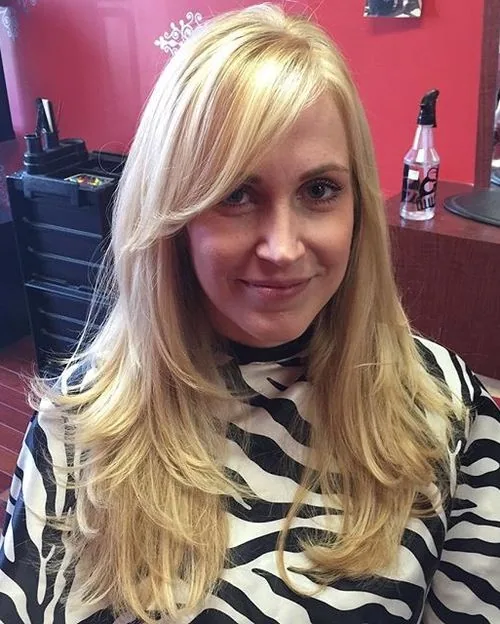 chest straight blonde layers with side swept fringe shown as a layered hairstyles for women over 60 idea