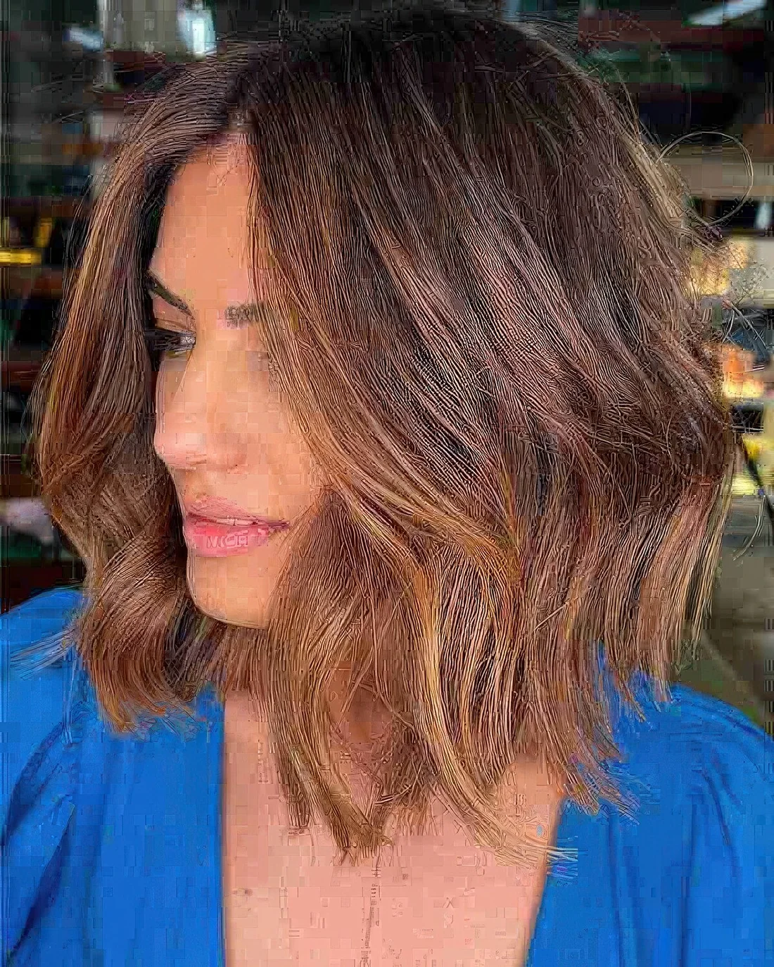 Brown layered long bob with caramel balayage and a darker root, with texture and a contrasting look.