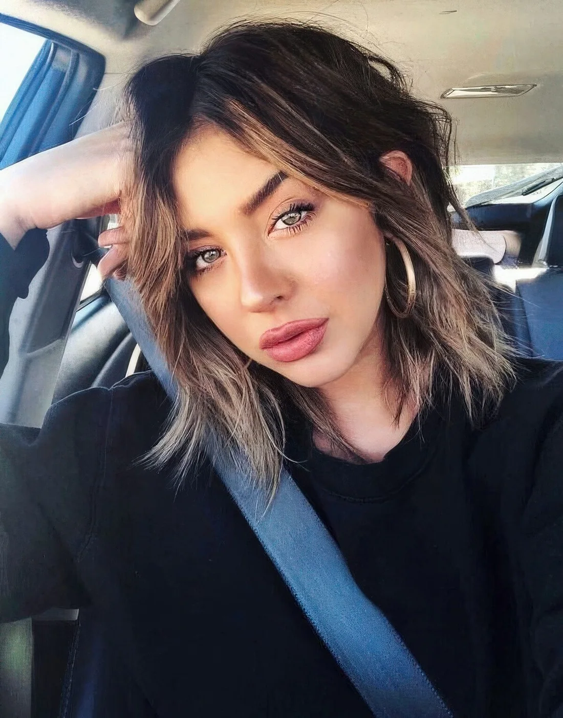 Layered bob with a darker root and lighter ends, with feathery layers.