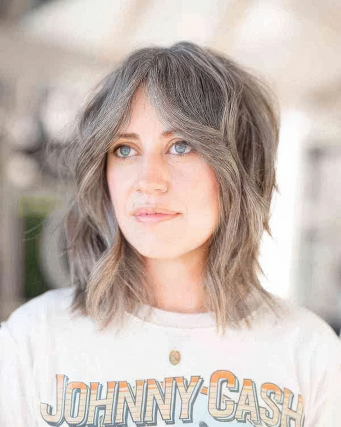 Messy layered long bob haircut with curtain bangs and textured layers and a greyish color that.
