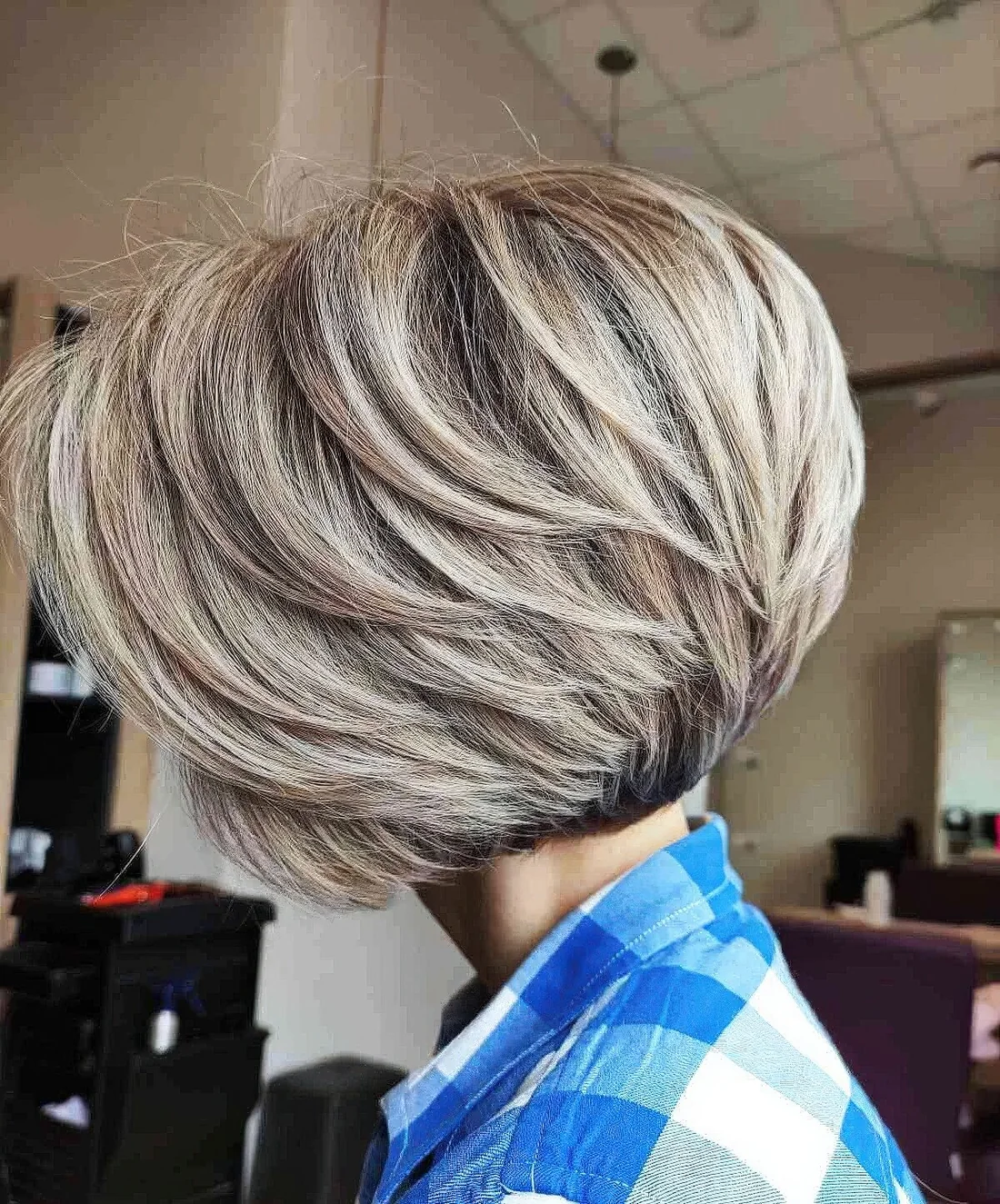Layered blonde pixie bob with darker root.