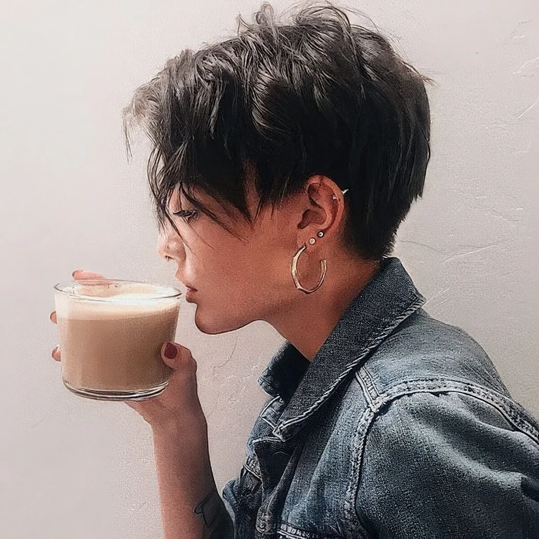 Layered brunette pixie haircut with textured waves.