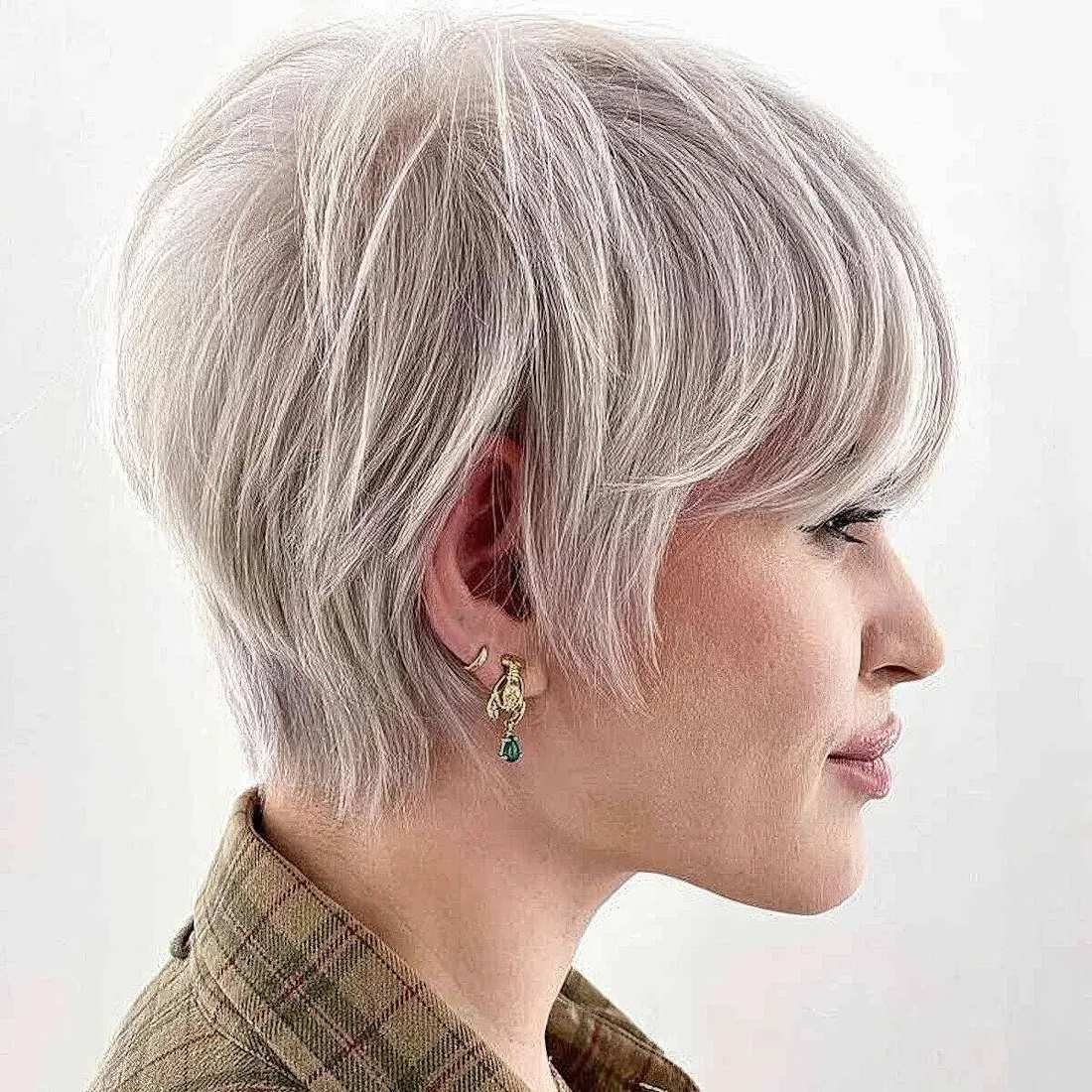 Platinum toned layered long pixie cut requires only a blow dry for a beautiful and stylish look.