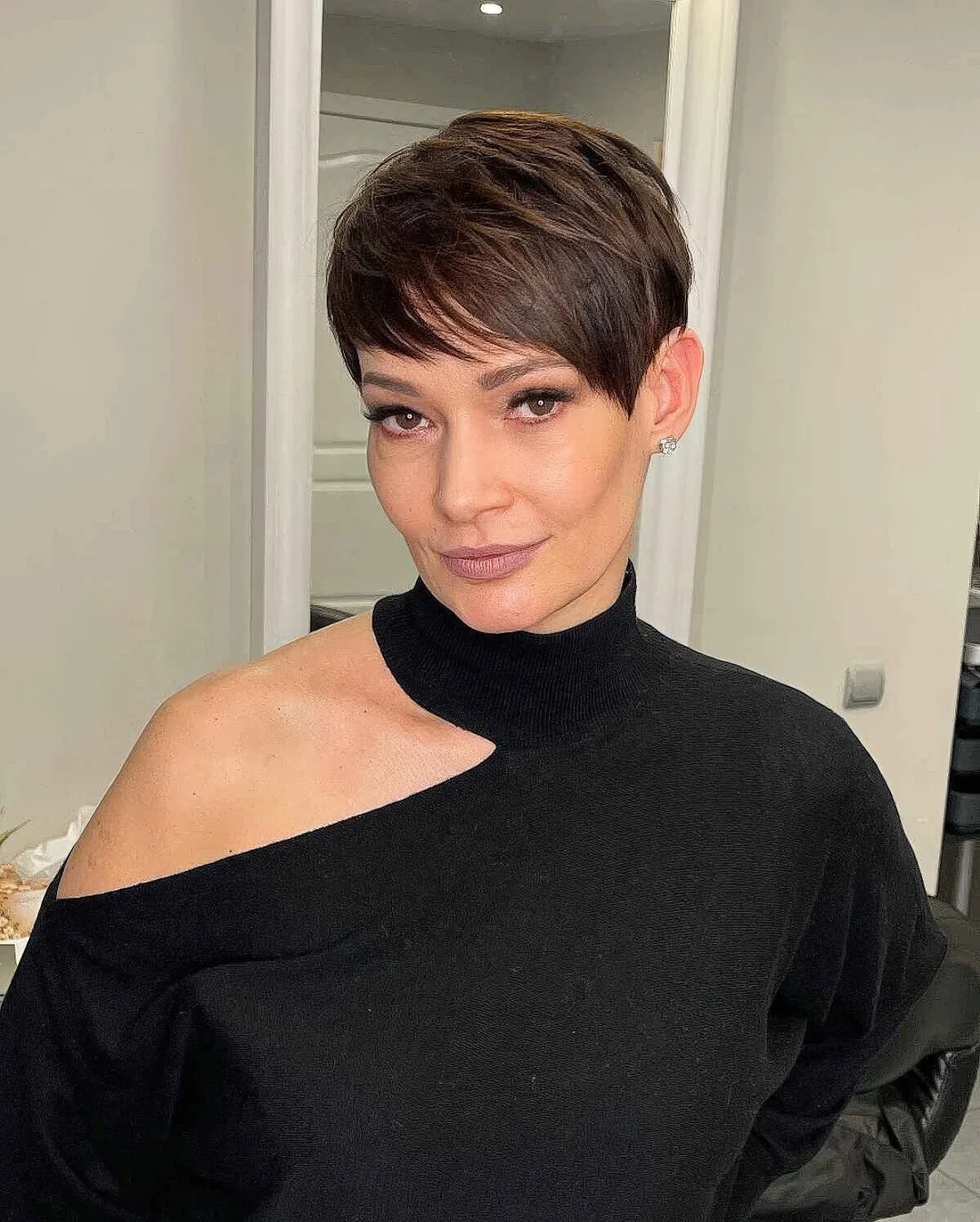 Photo showing short layered pixie haircut, with the hairstyle clearly visible.