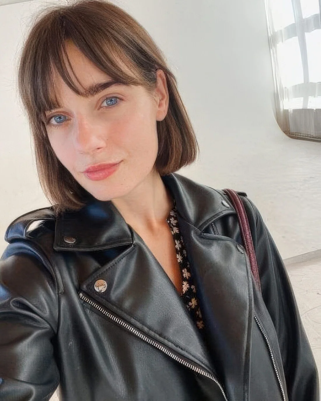 Classic blunt brunette bob with wispy bangs.