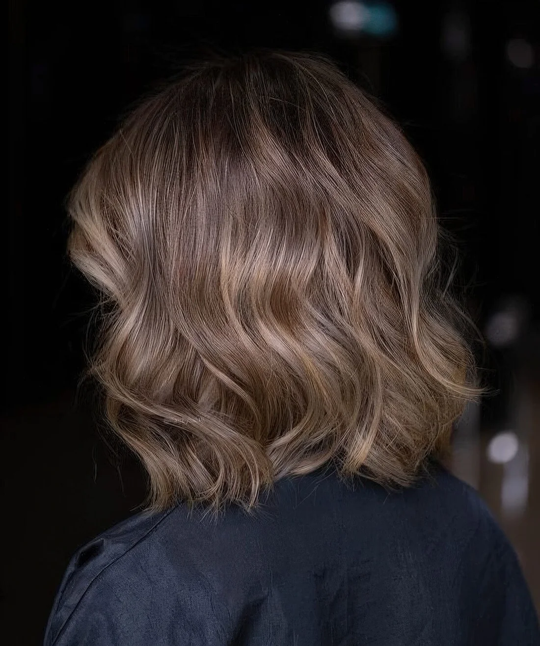 Long bronde bob with golden blonde highlights and waves.