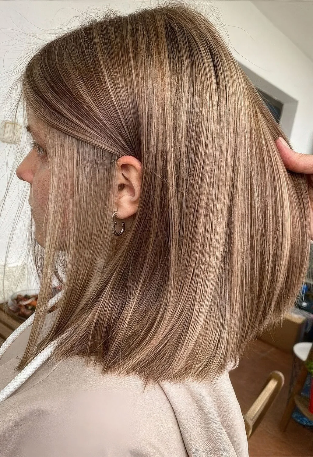 Light brown long bob with straight hair.
