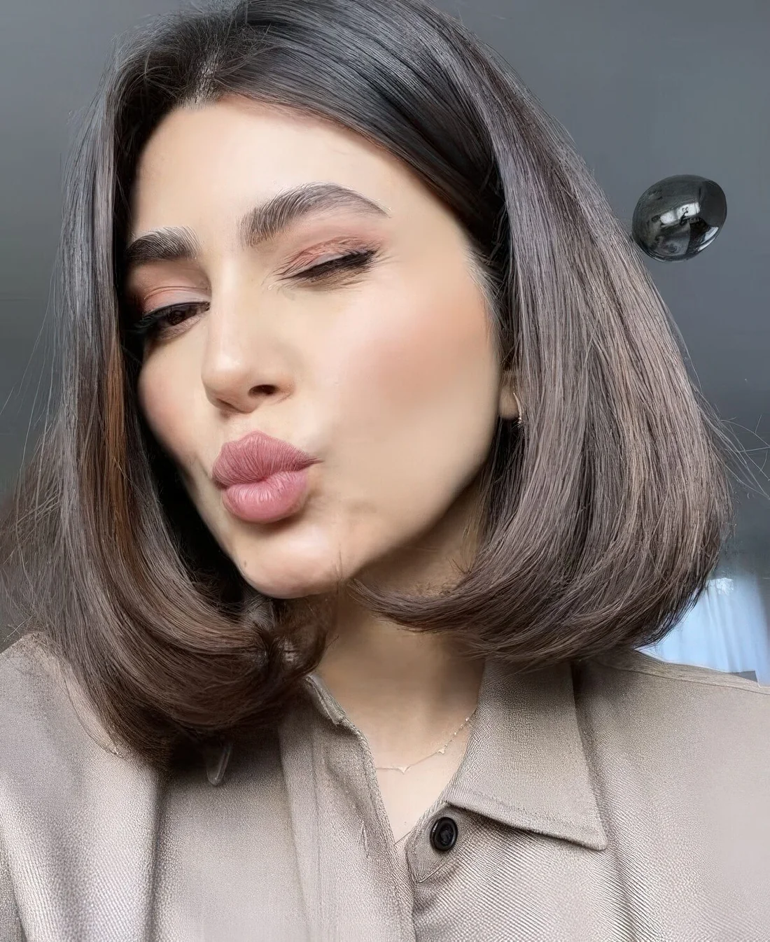 Depe brown liquid bob with center part and much volume.